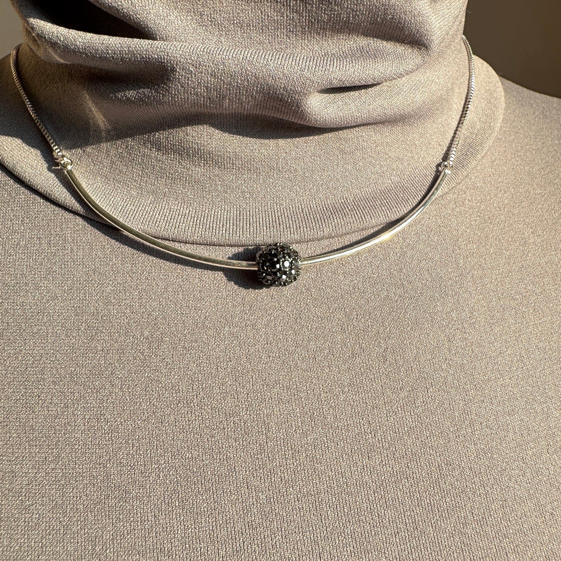 Pilgrim silver necklace with crystal-encrusted sphere worn on neck