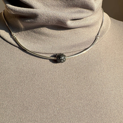 Pilgrim silver necklace with crystal-encrusted sphere worn on neck