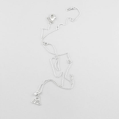 Pilgrim necklace with triangle charm and crystal arranged on light background