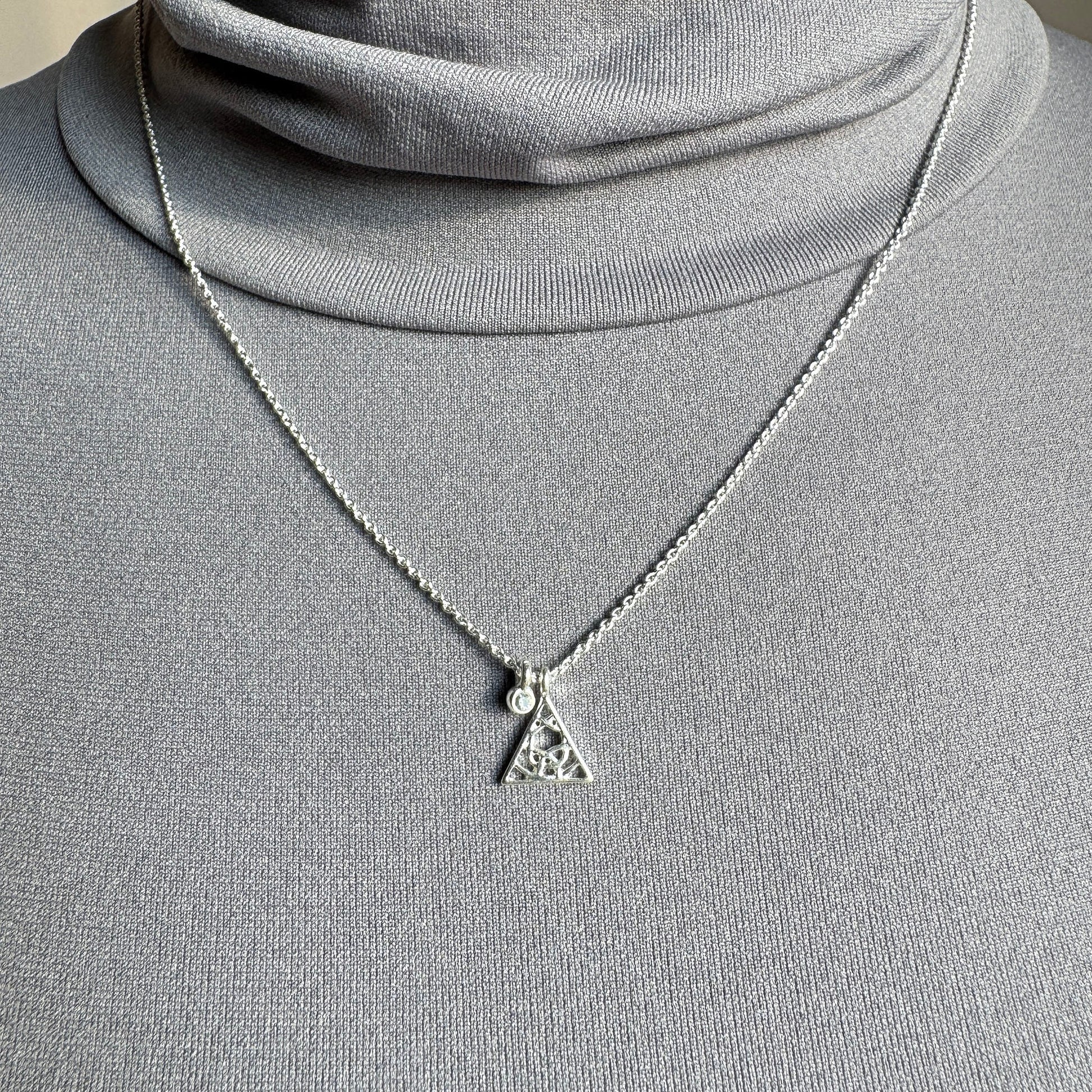 Pilgrim silver necklace with delicate triangle pendant and crystal worn on neck
