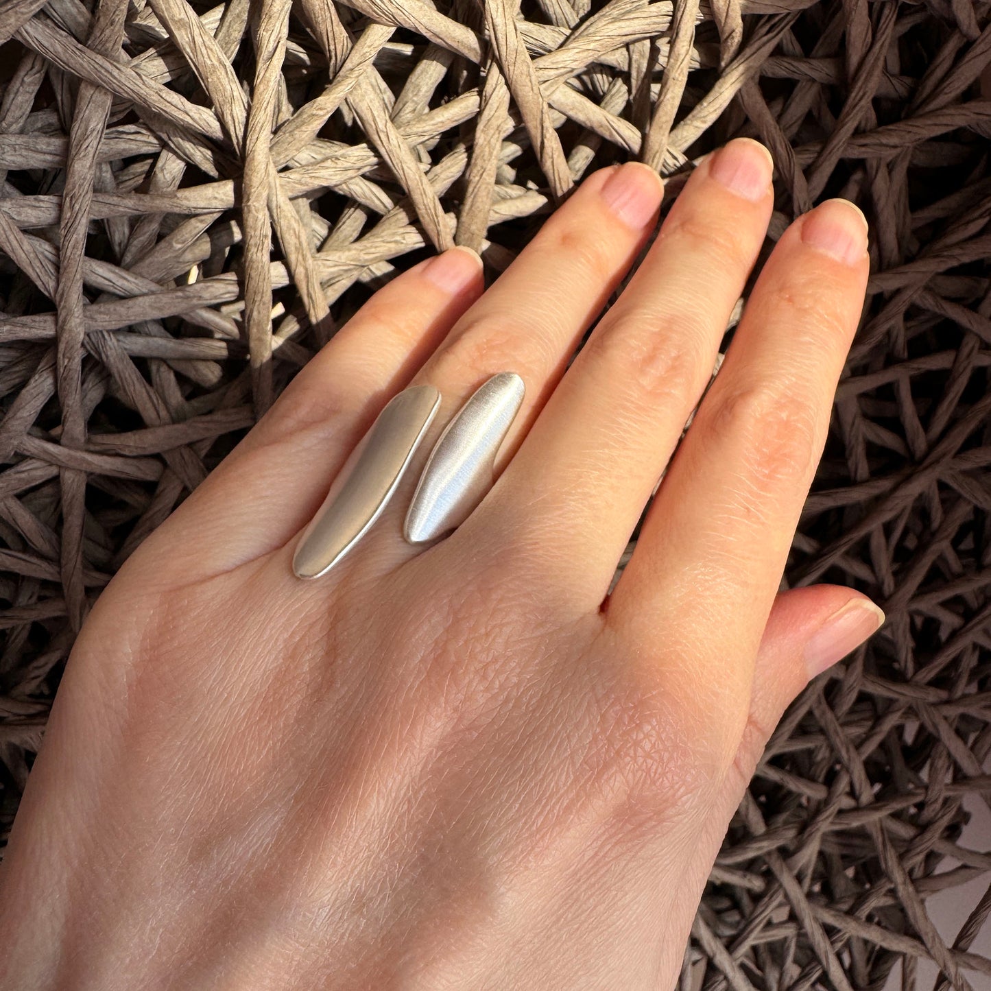 Artistic Pilgrim ring worn on the hand with an open asymmetric design