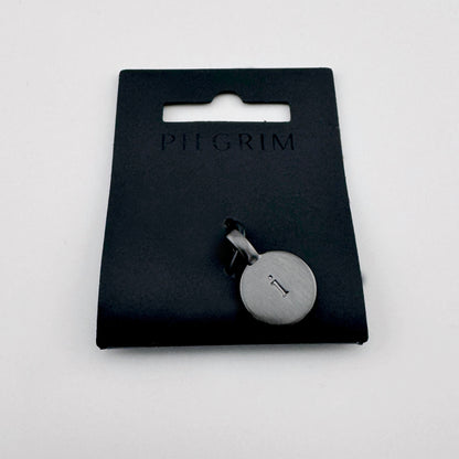 Pilgrim letter I pendant in dark graphite tone on branded packaging