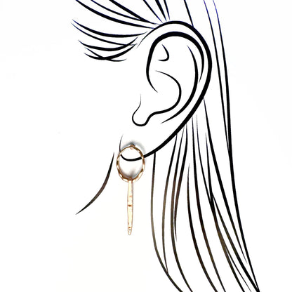 Pilgrim long hoop earrings in warm gold with subtle hammered texture and a tiny crystal tip