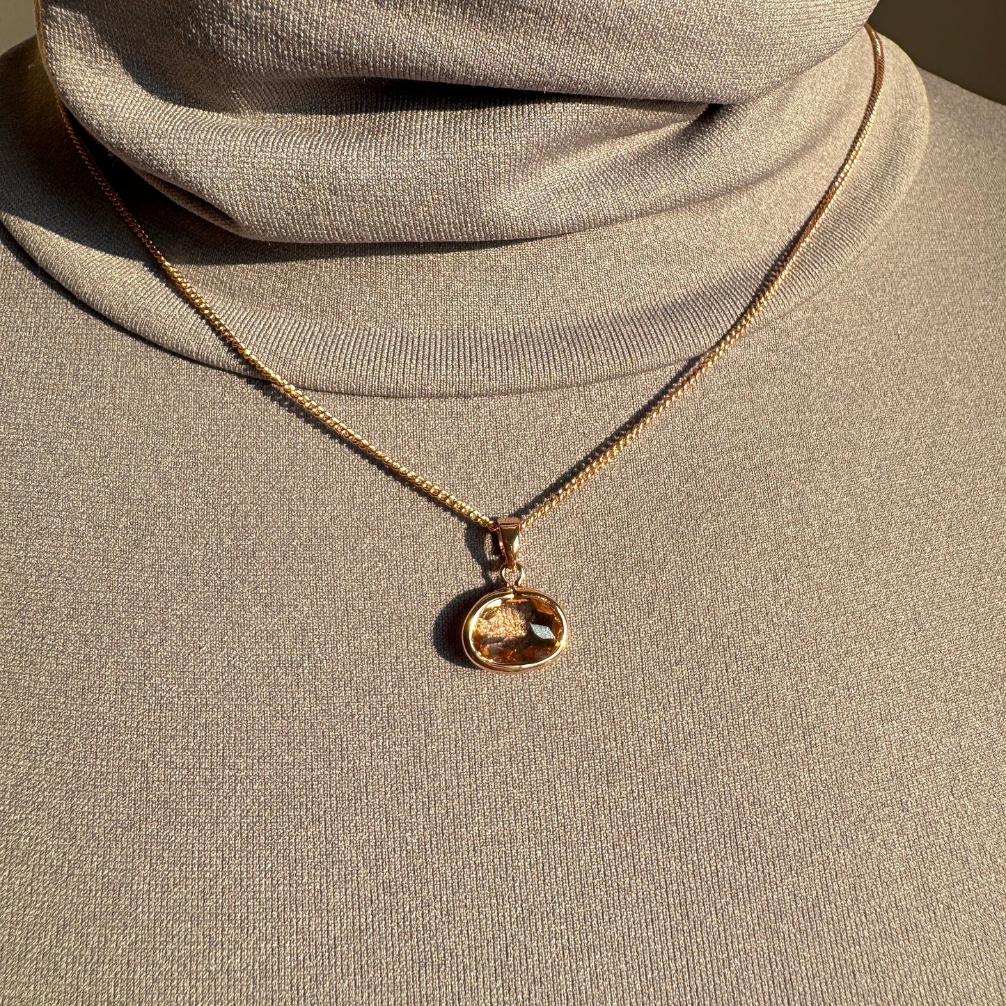 Pilgrim necklace with faceted peach crystal worn on mannequin