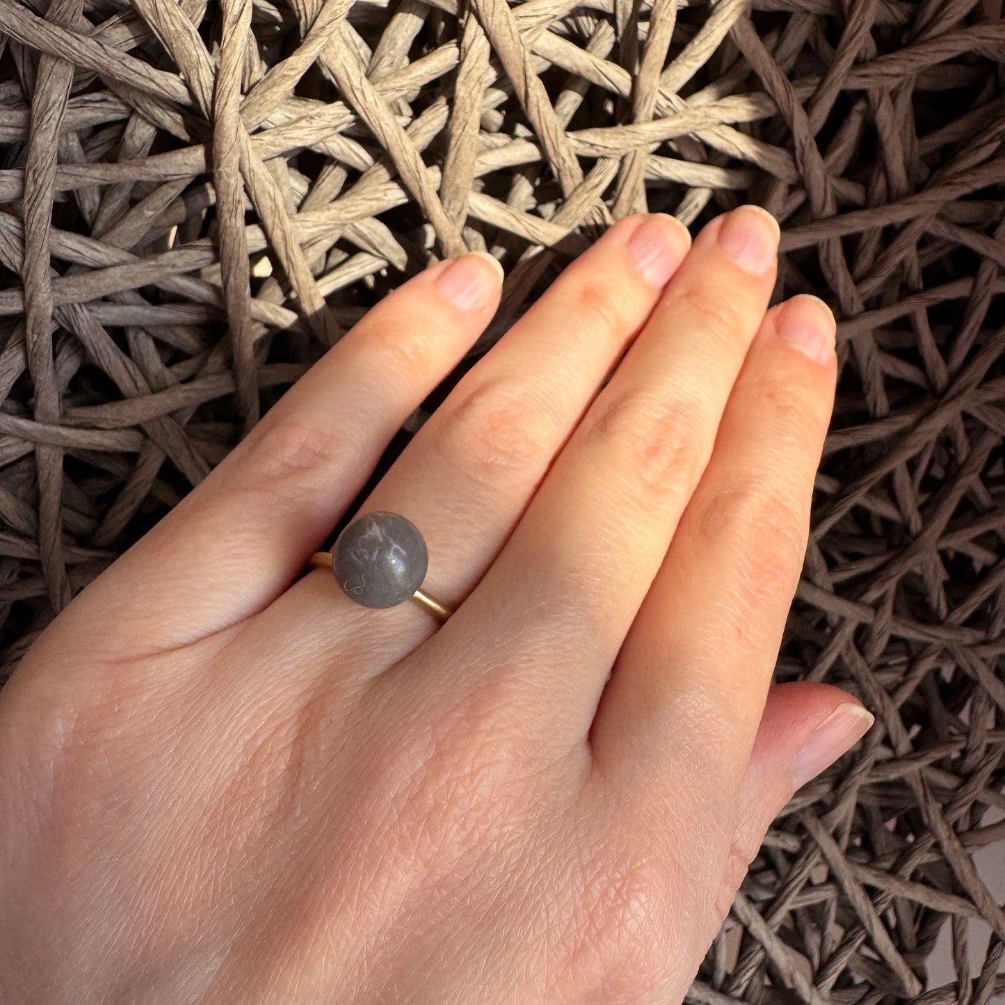 Adjustable Pilgrim ring worn with a matte gray stone and satin finish