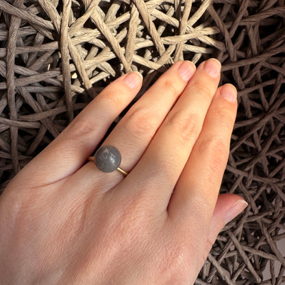 Adjustable Pilgrim ring worn with a matte gray stone and satin finish
