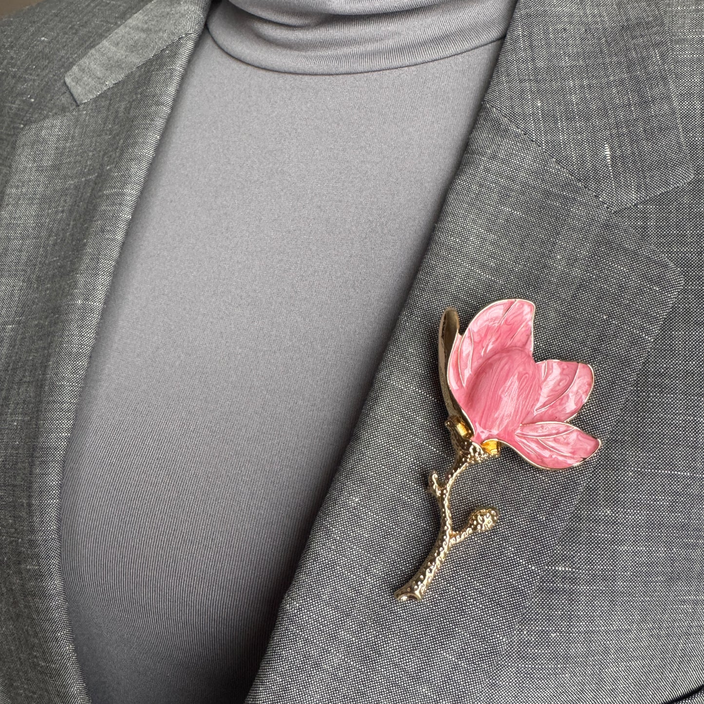Pink flower brooch Sonata worn on a blazer with glossy enamel petals
