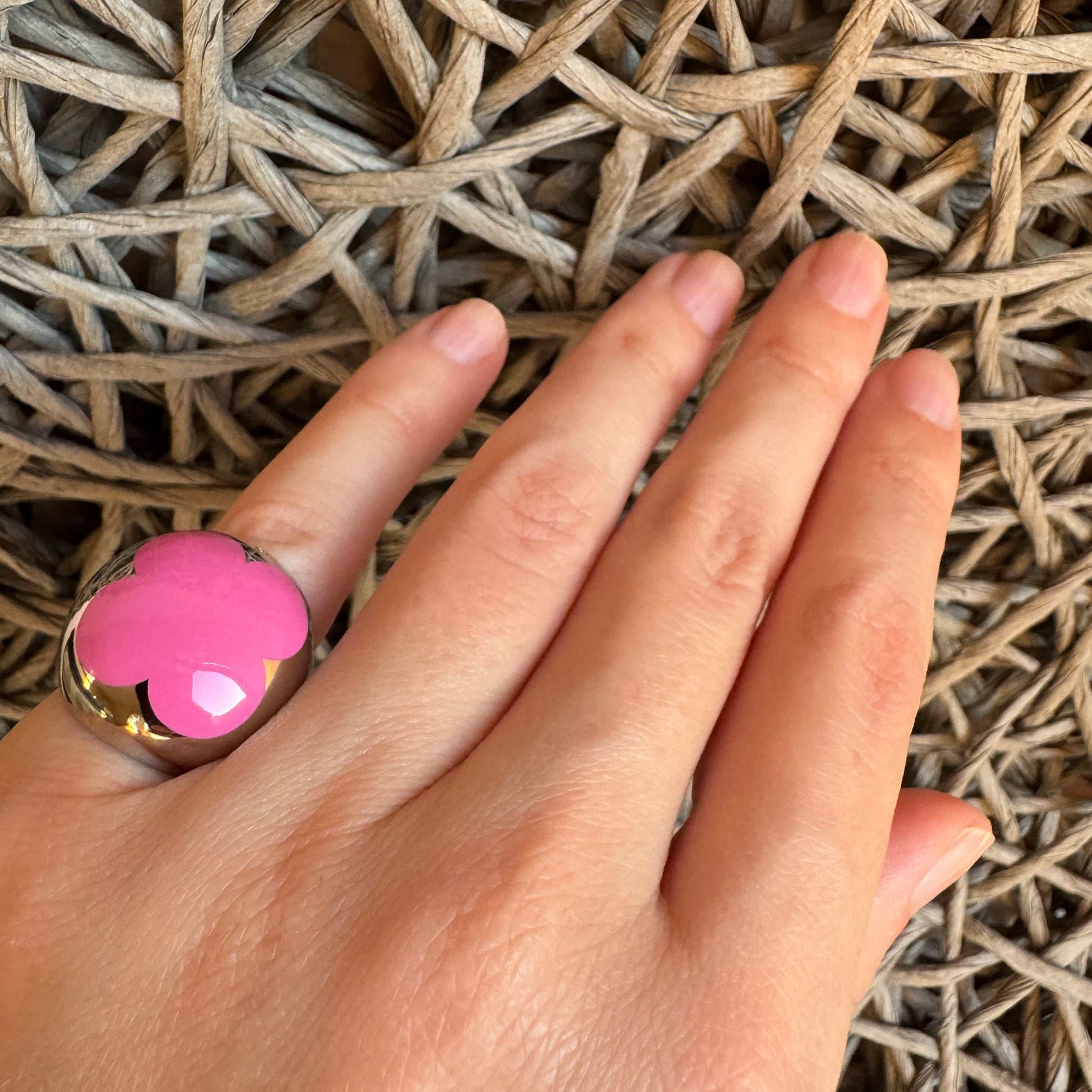 Pink enamel flower ring by Bliss Gioielli worn on hand