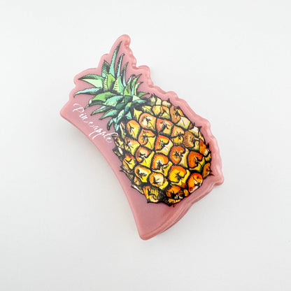 Pink pineapple hair claw with a glossy finish and a playful tropical accent