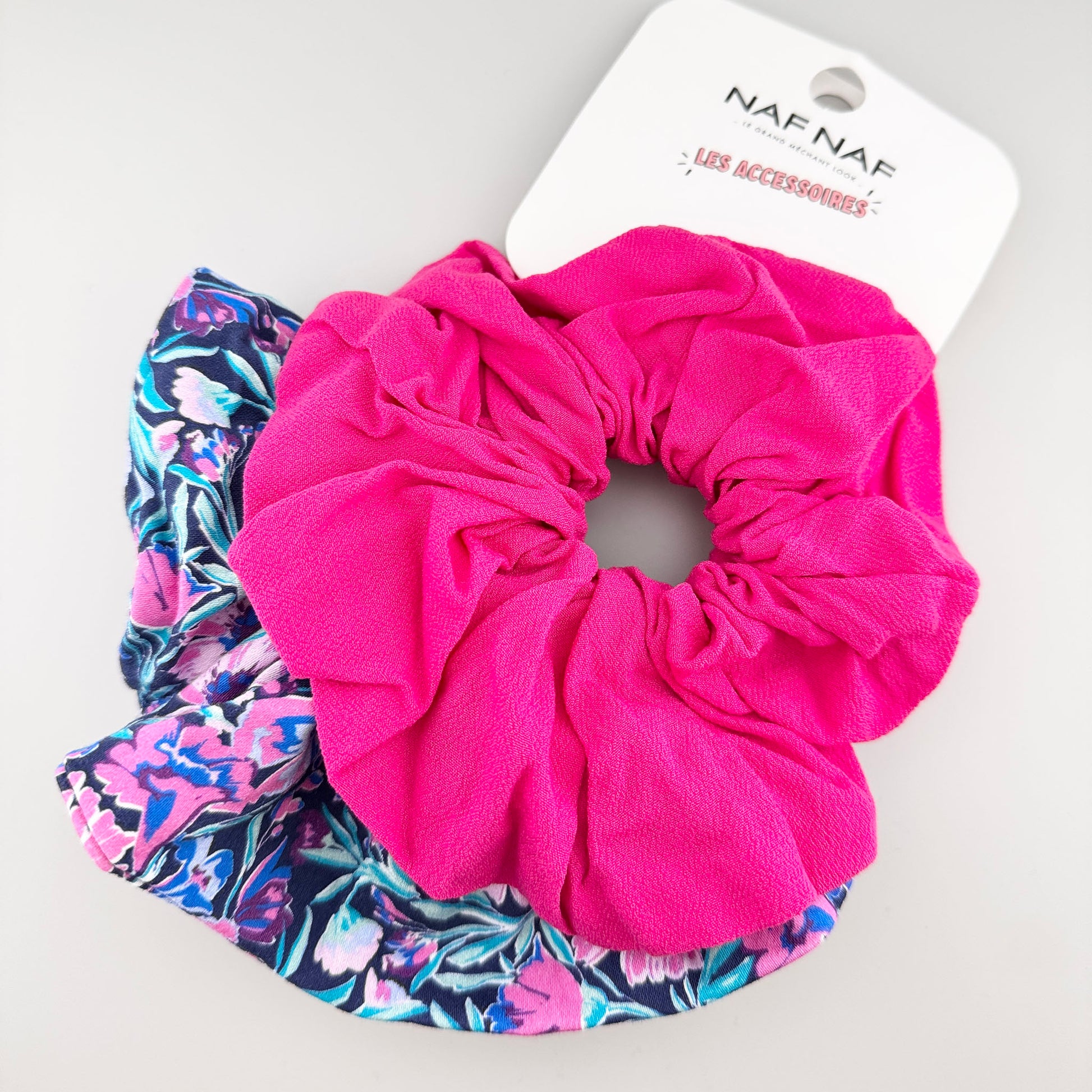 Large pink and floral scrunchies by Naf Naf in a soft, voluminous shape