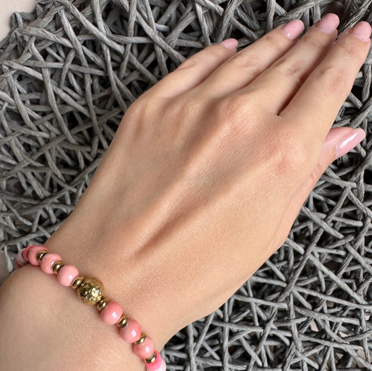 Blush pink and pearl white bracelet with matte and gold details, featuring a hammered gold sphere, by Ikita.