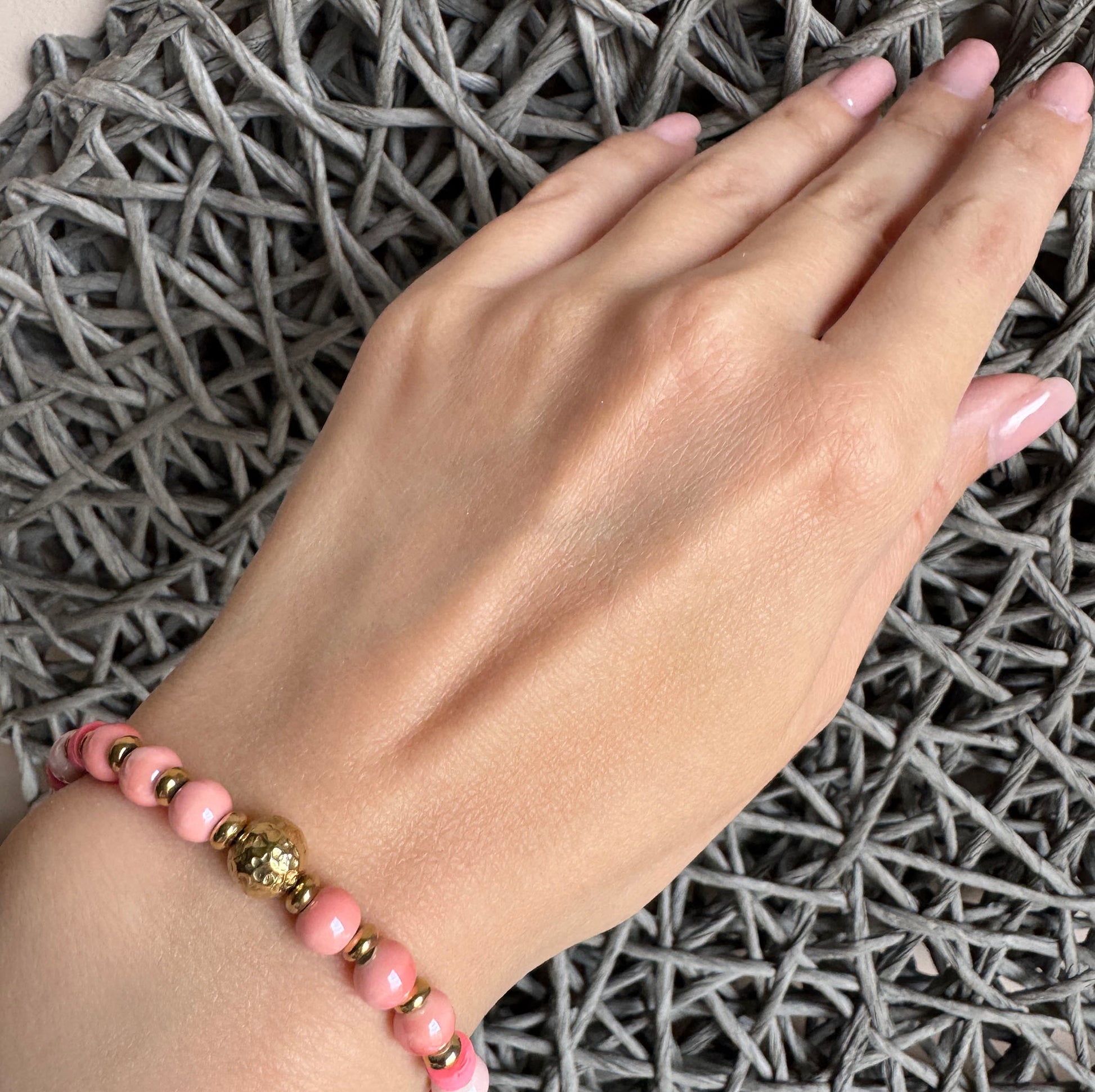 Blush pink and pearl white bracelet with matte and gold details, featuring a hammered gold sphere, by Ikita.