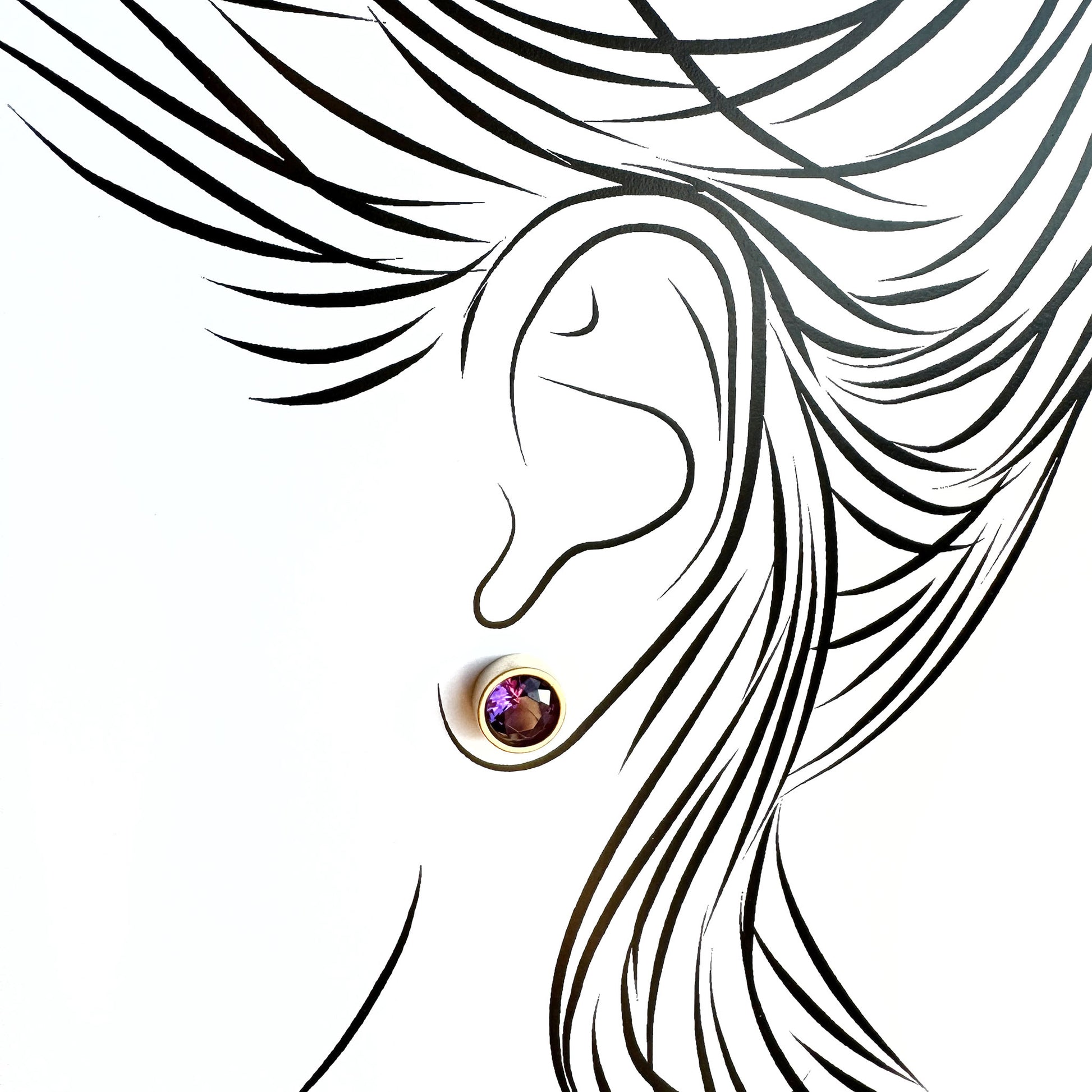 Silver quartz stud earrings worn on ear with subtle light reflection