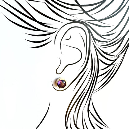 Silver quartz stud earrings worn on ear with subtle light reflection