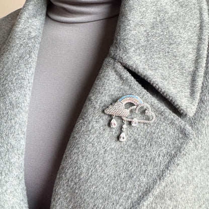 Rainbow cloud brooch Maravillas worn on a coat with crystal drops