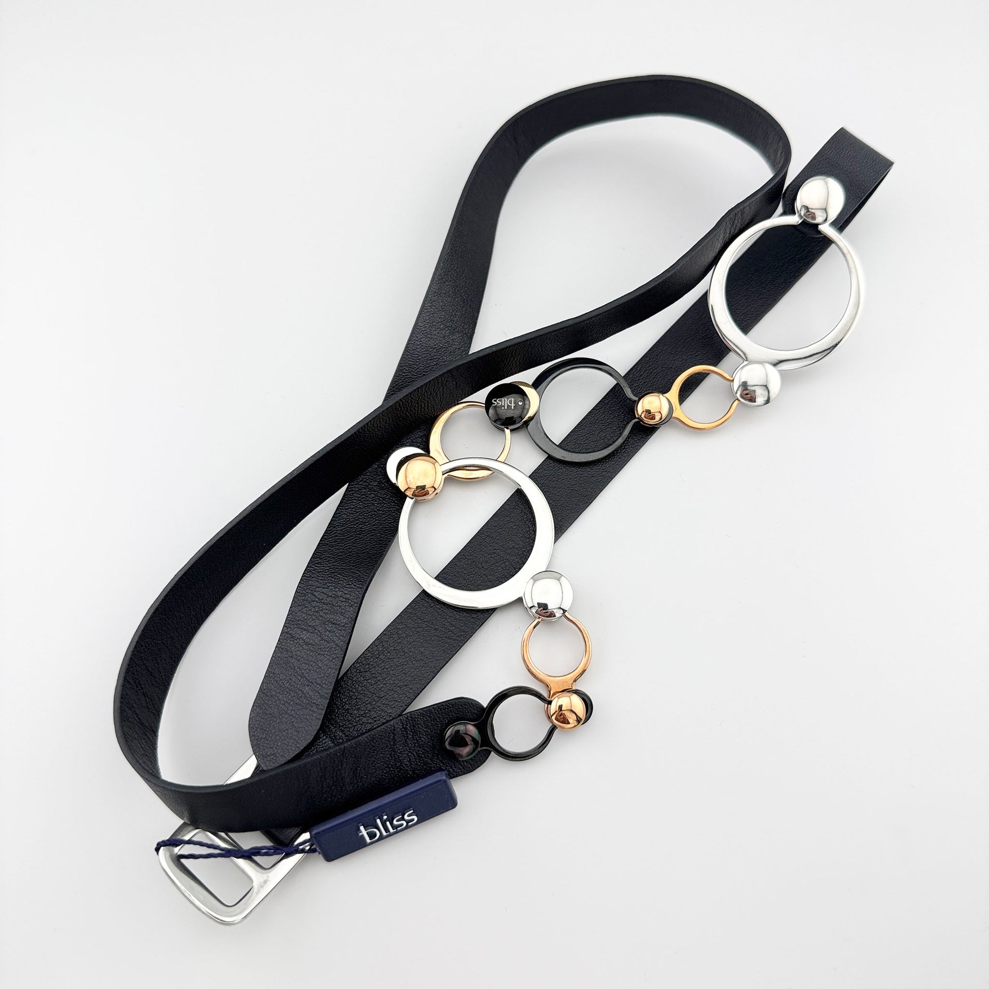 Leather strap necklace with mixed metal rings and a bold geometric arrangement
