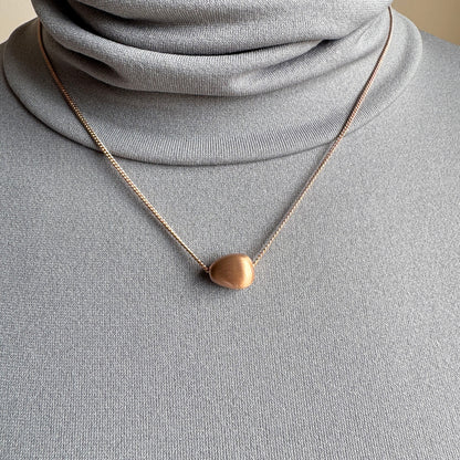 Rose gold Pilgrim necklace with soft matte oval pendant worn delicately