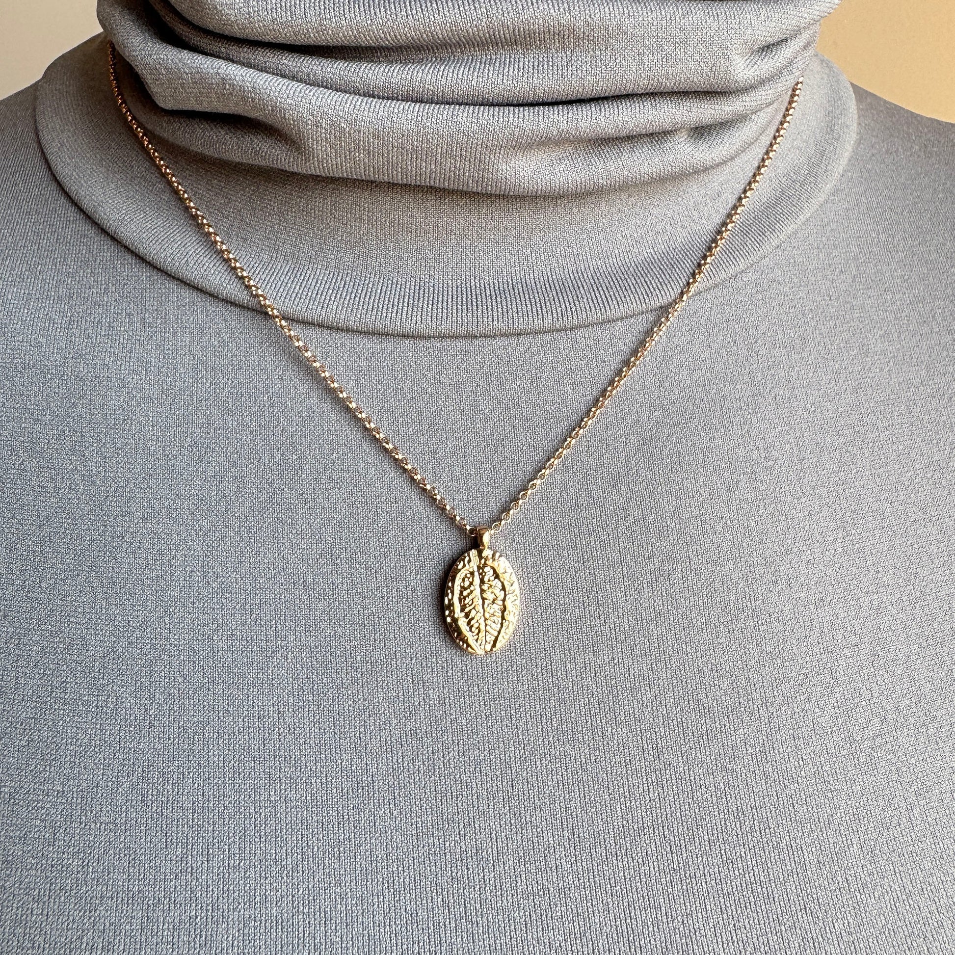 Rose gold Pilgrim necklace with oval leaf pendant worn layered on neck