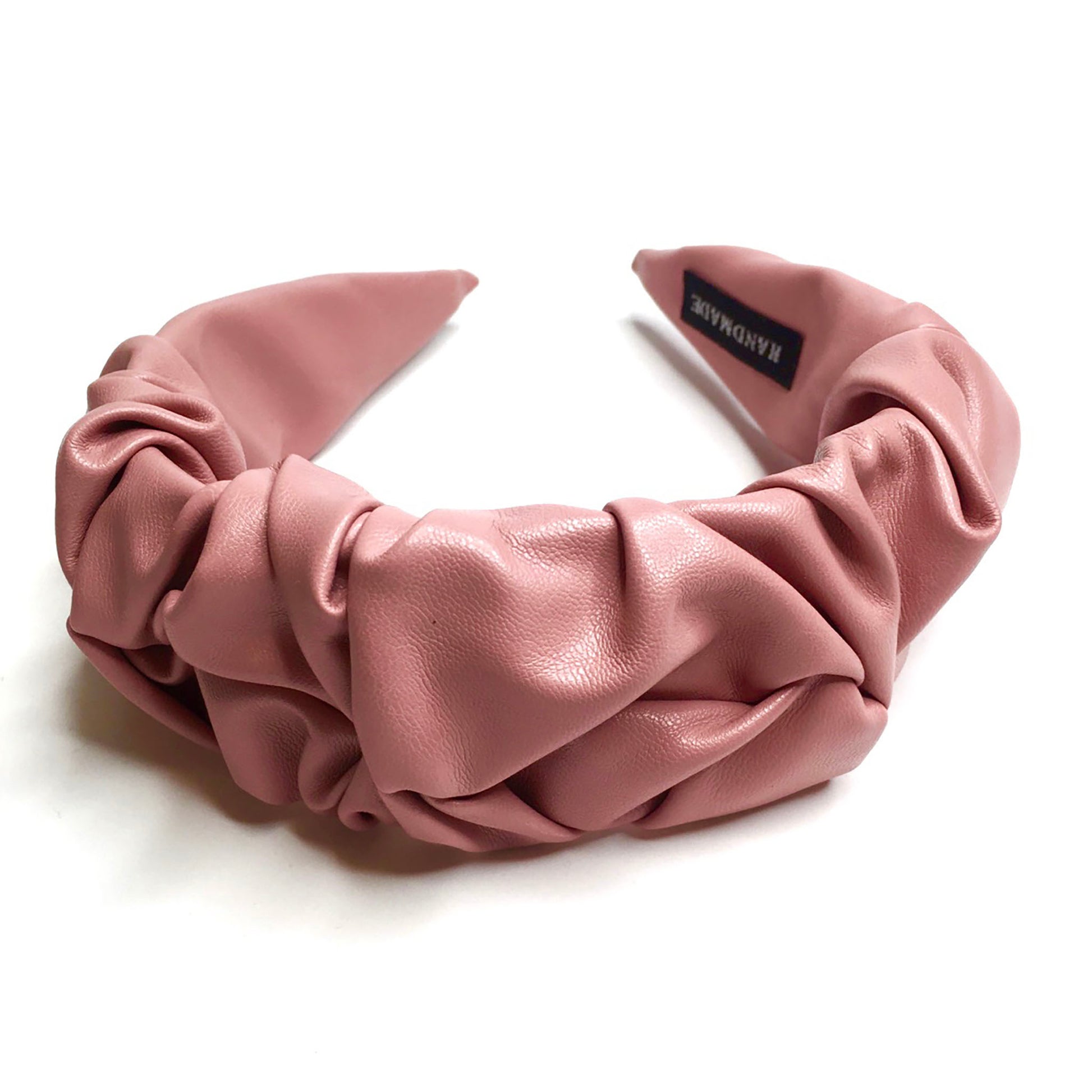 Pink faux leather headband with a ruched shape and a soft elegant finish