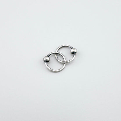 Elegant LULU Copenhagen silver piercer hoops with small polished ball detail
