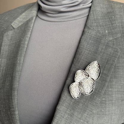 Silver disc brooch Sonata worn on a blazer with a textured layered design