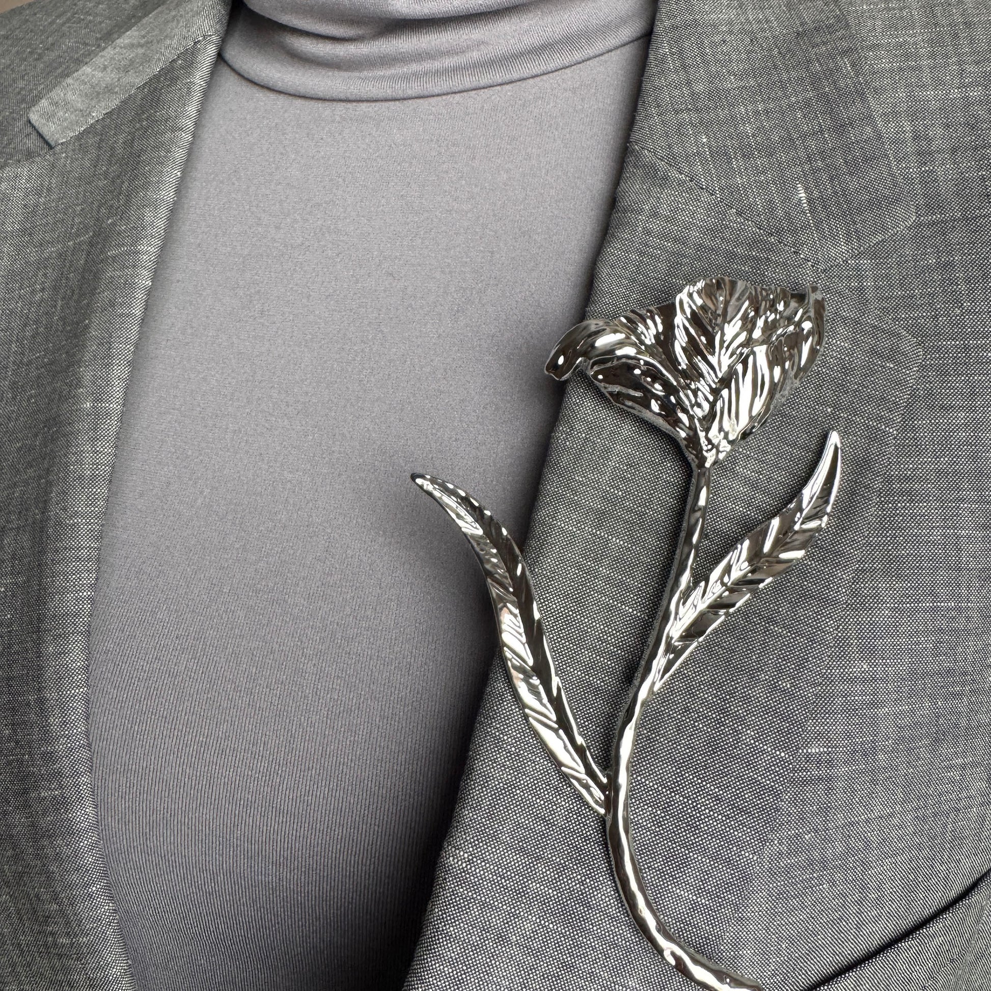 Modern silver flower brooch Sonata worn on a blazer with an organic sculptural shape