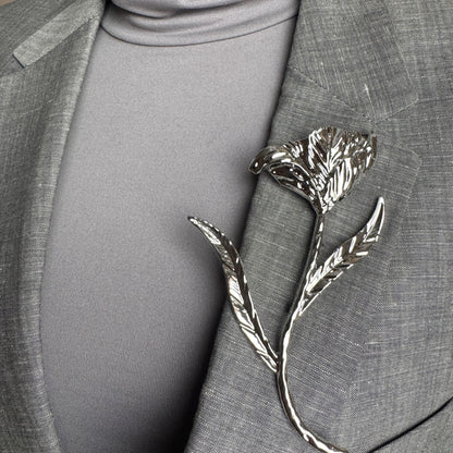 Modern silver flower brooch Sonata worn on a blazer with an organic sculptural shape
