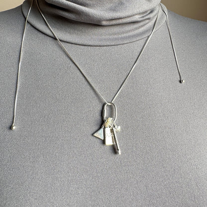Silver Pilgrim necklace with multiple charms worn as a layered look