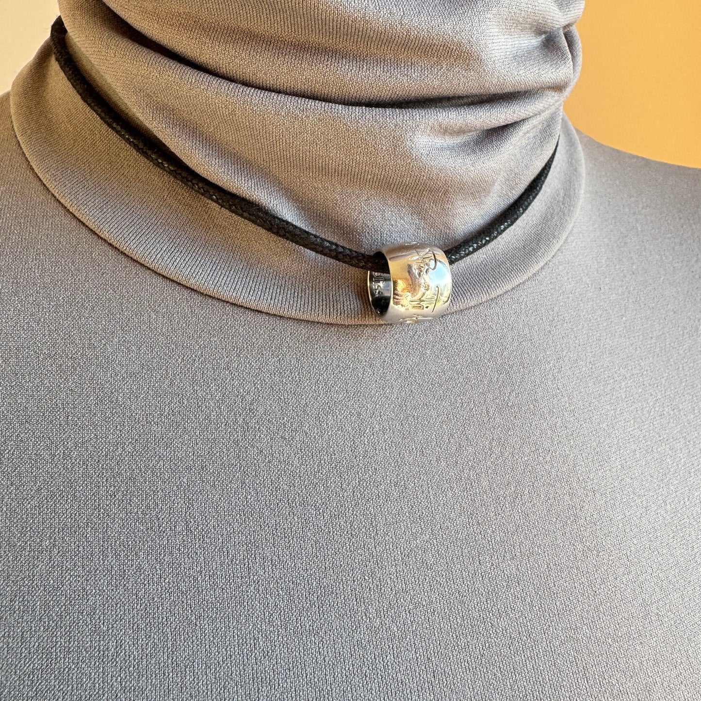 925 silver necklace on a black cord with a subtle engraved charm