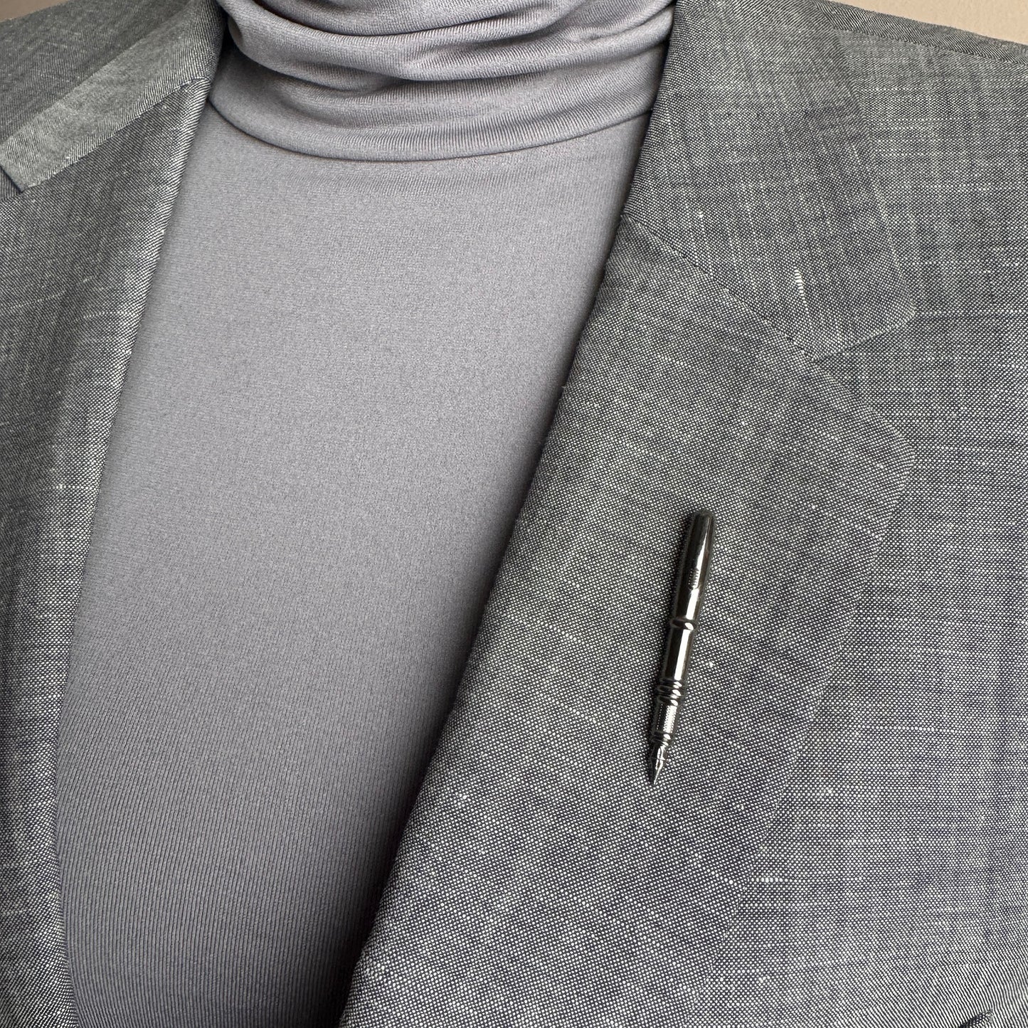 Silver fountain pen pin Sonata worn on a blazer with a polished minimalist finish