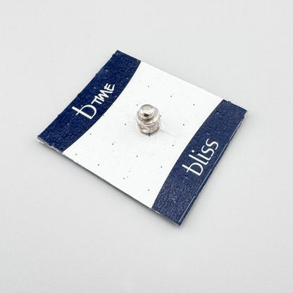Silver screw charm by Bliss Gioielli displayed on a branded card