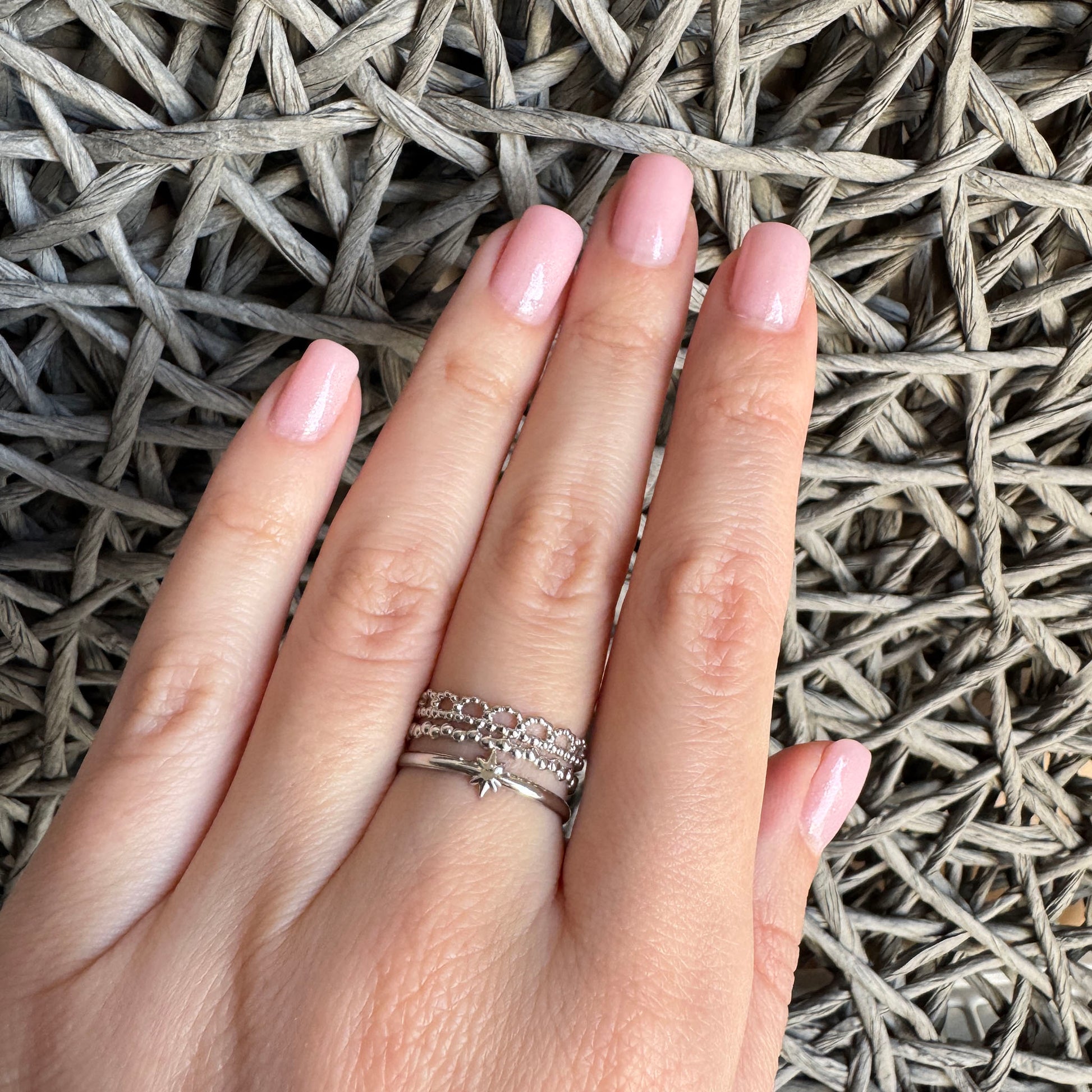 Silver triple IRL ring with star motif worn gracefully on hand