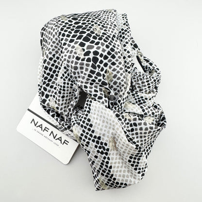Black and white Naf Naf headband with a subtle gold shimmer and elastic back