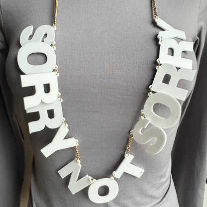 Statement letter necklace Sonata worn on the neck with white letters and a gold-tone chain