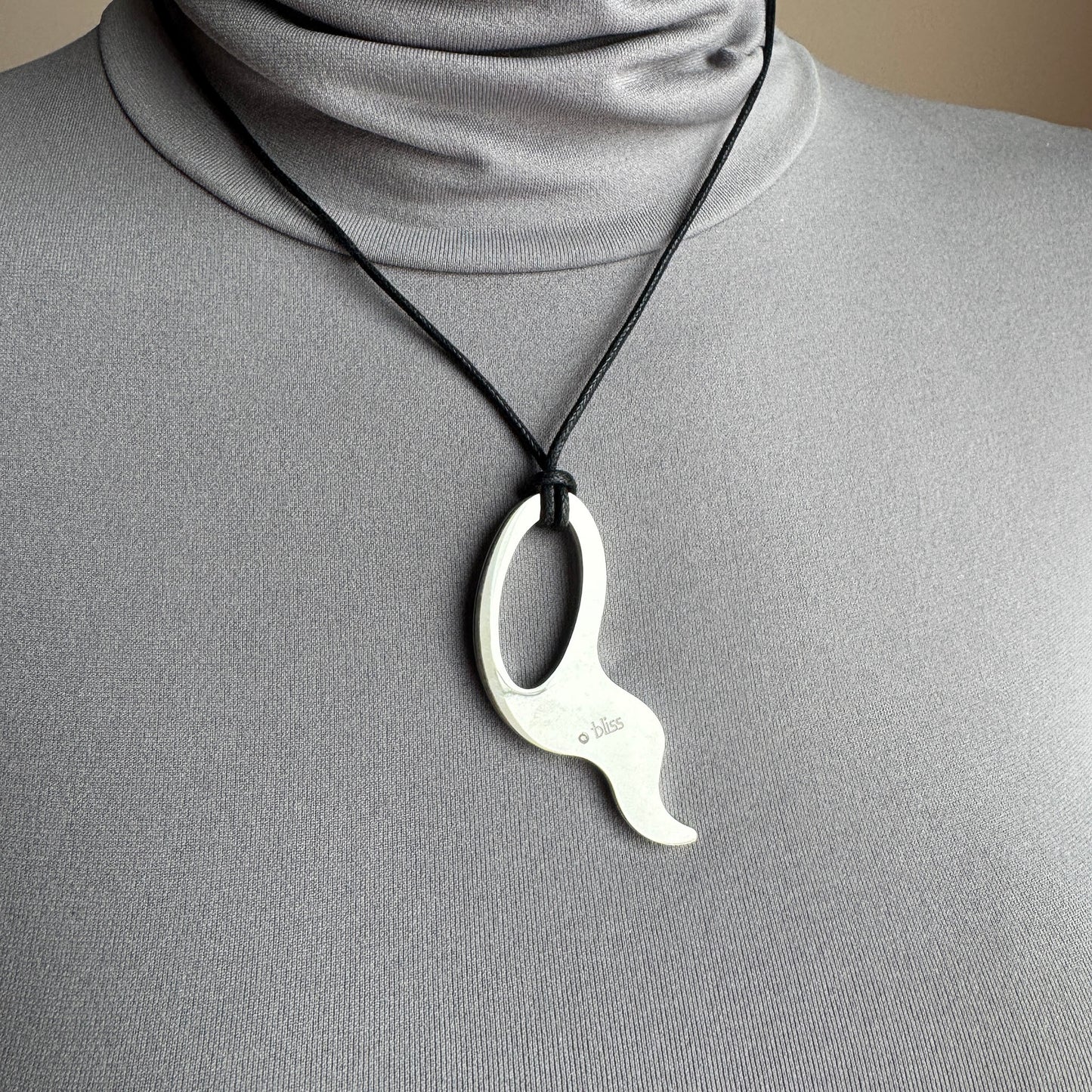 Steel necklace Bliss Gioielli worn on a black cord with an asymmetrical polished pendant