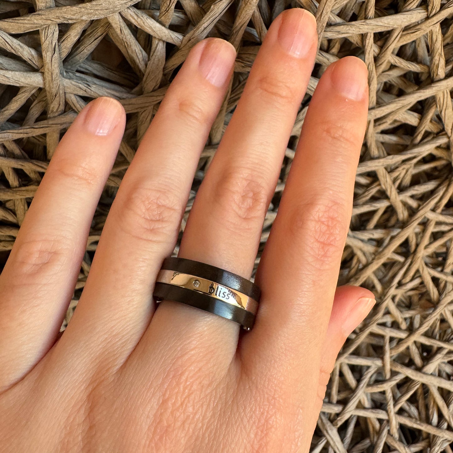 Steel and wood ring by Bliss Gioielli worn on the hand