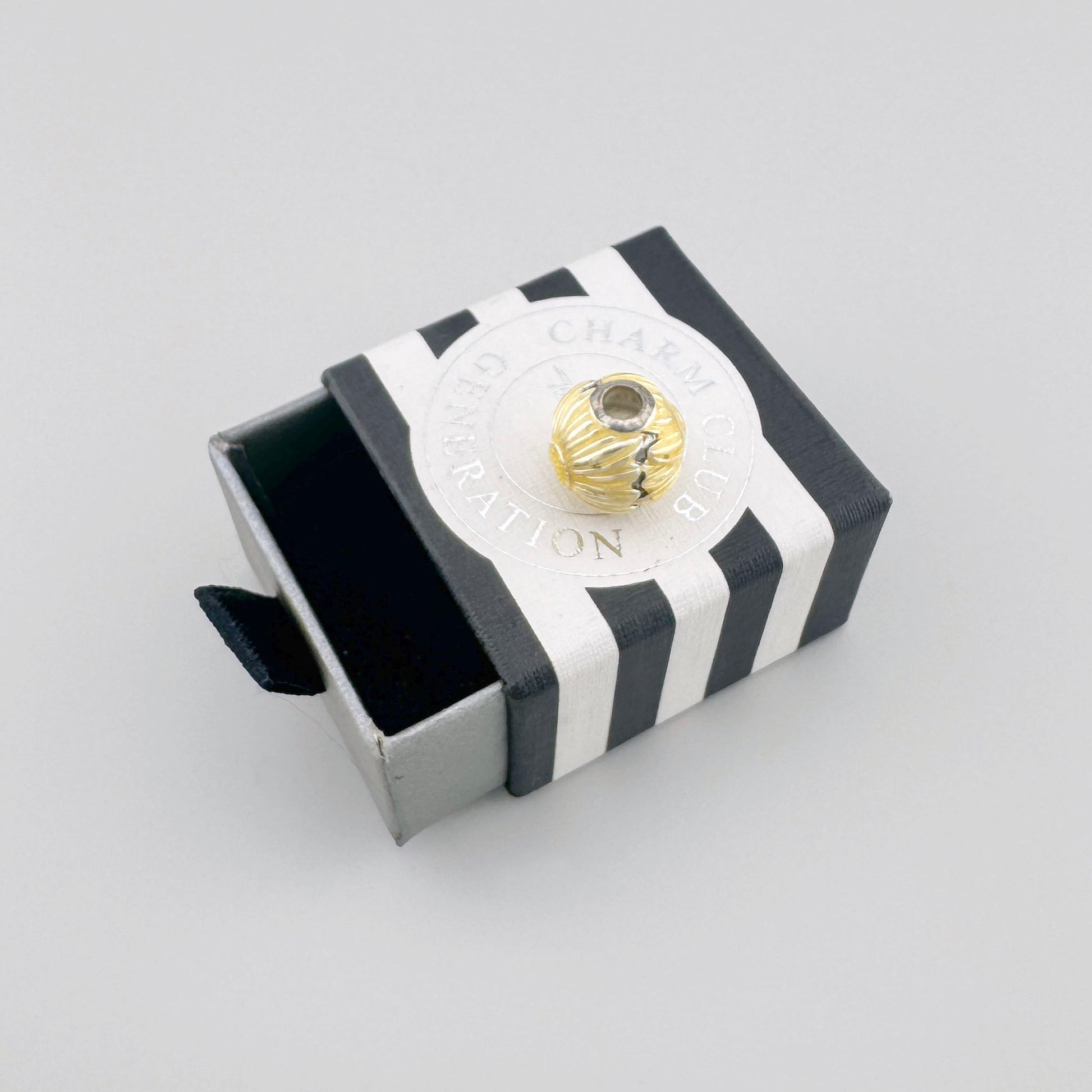 Thomas Sabo sun sphere charm displayed beside its branded box