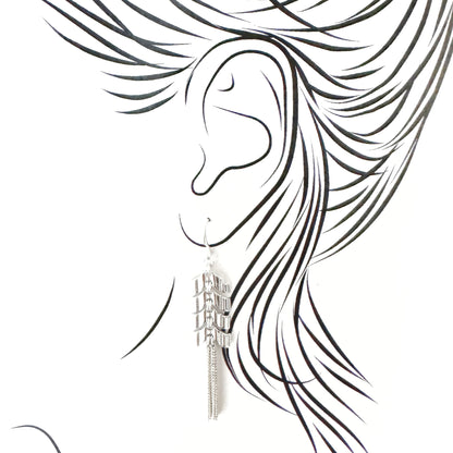 Long tassel earrings with fine chain fringes, arrow-shaped links and airy swing for easy movement