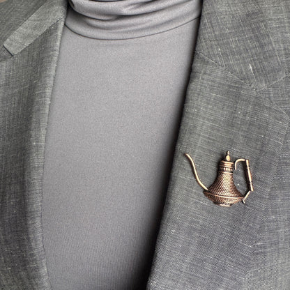 Oriental teapot brooch Sonata worn on a blazer with a warm vintage metal finish