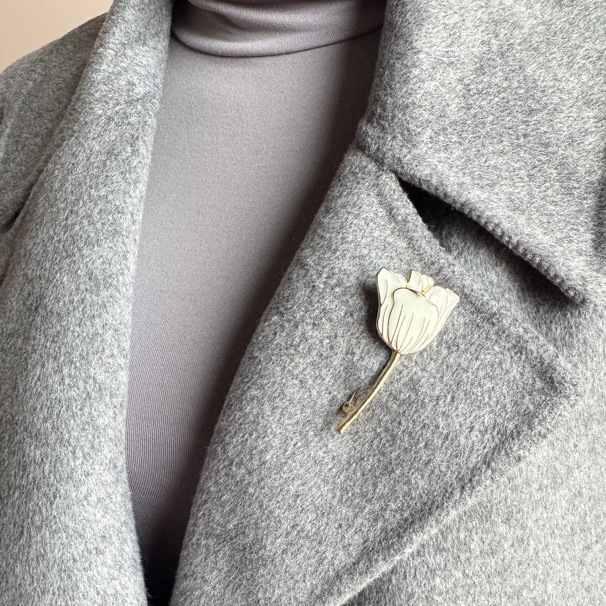 Tulip brooch Sonata worn on a coat with cream enamel and a gold-tone finish