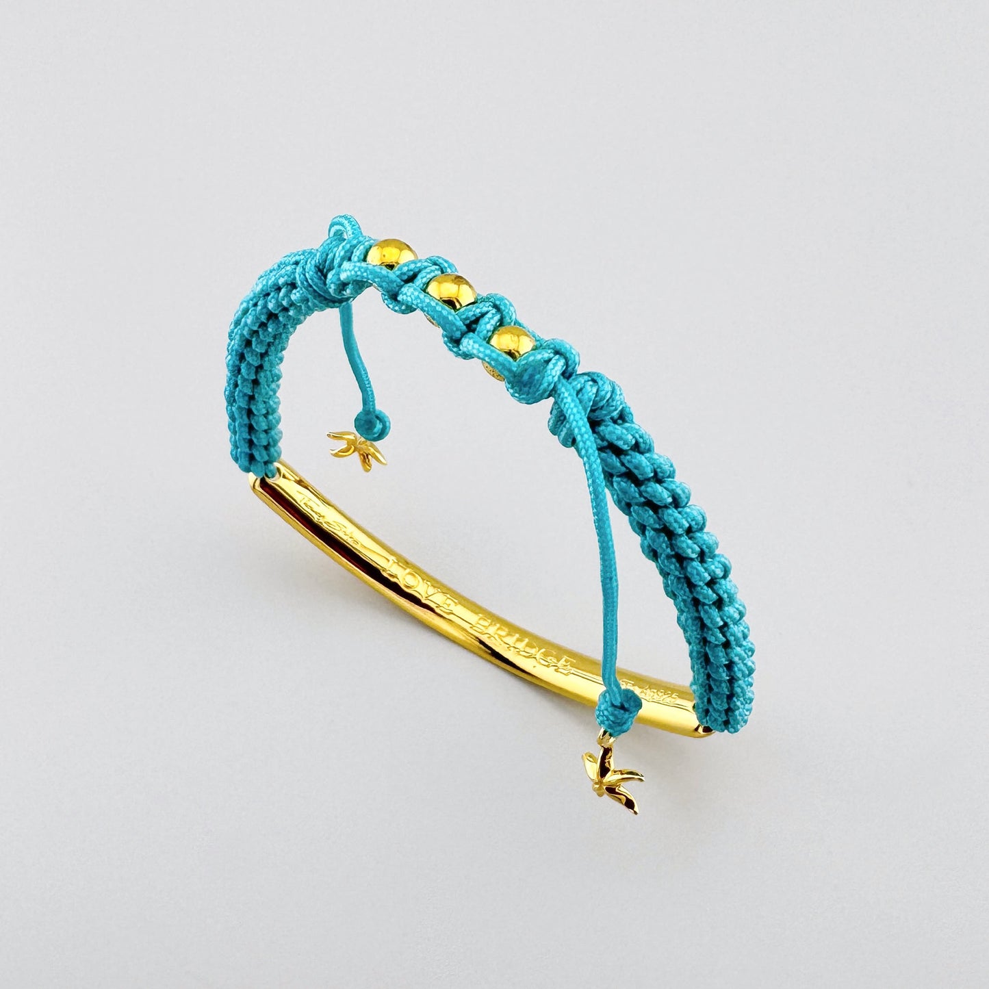 Türkisfarbenes Armband von Thomas Sabo mit geflochtenem Band und goldfarbenem Detail