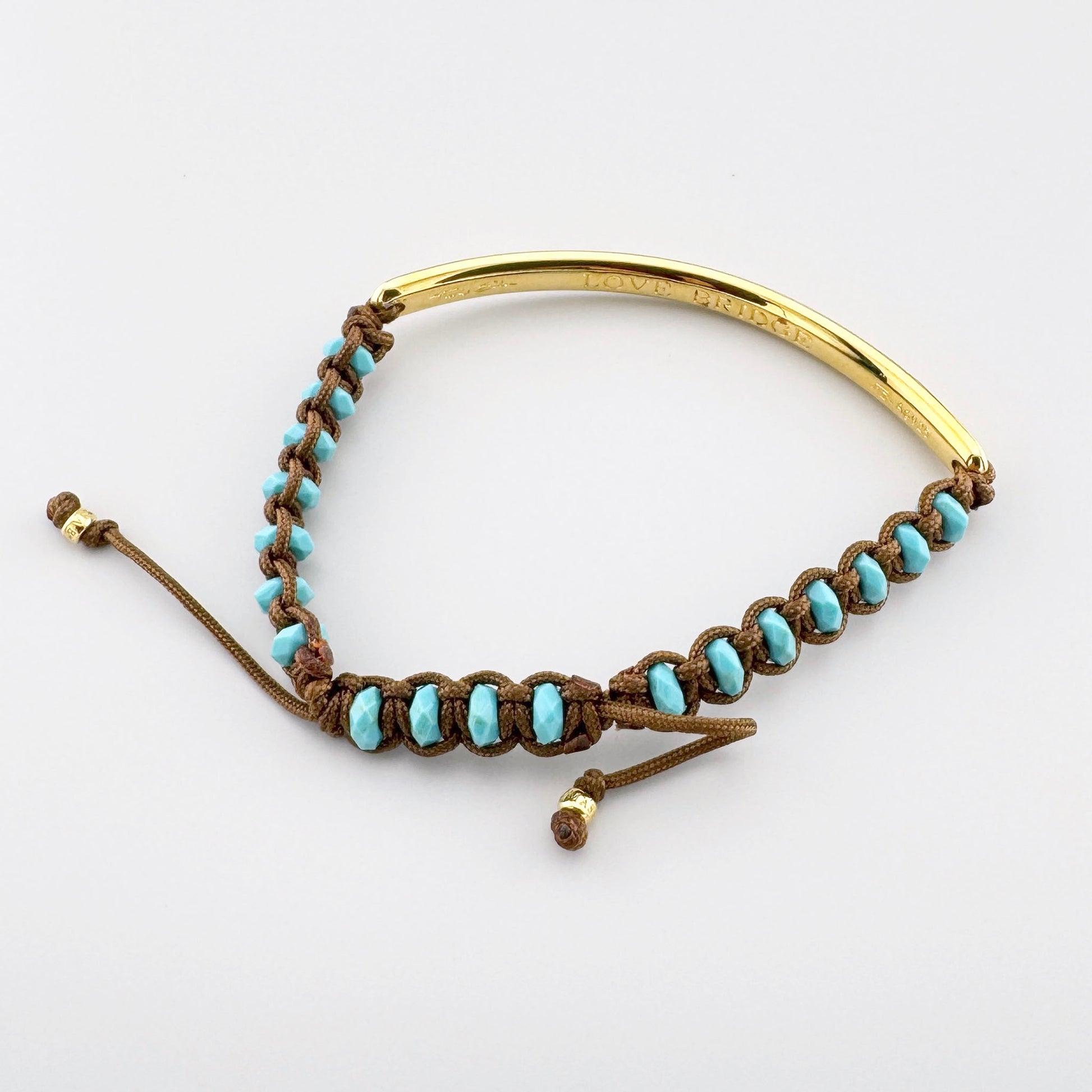 Gold-plated Thomas Sabo Love Bridge bracelet with turquoise stones and a warm brown adjustable cord
