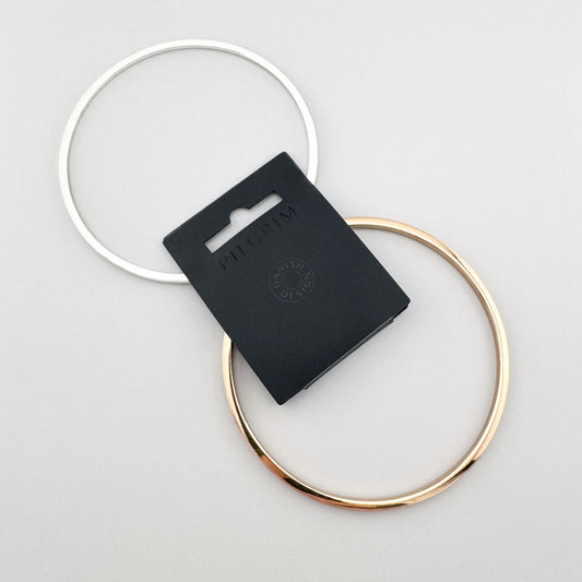 Zestaw dwóch cienkich bransoletek Pilgrim w kolorze srebra i złota ułożonych razem