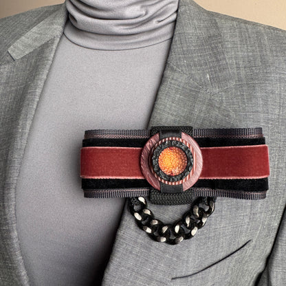 Velvet brooch Sonata worn on a blazer with ribbon layers and a bold chain detail