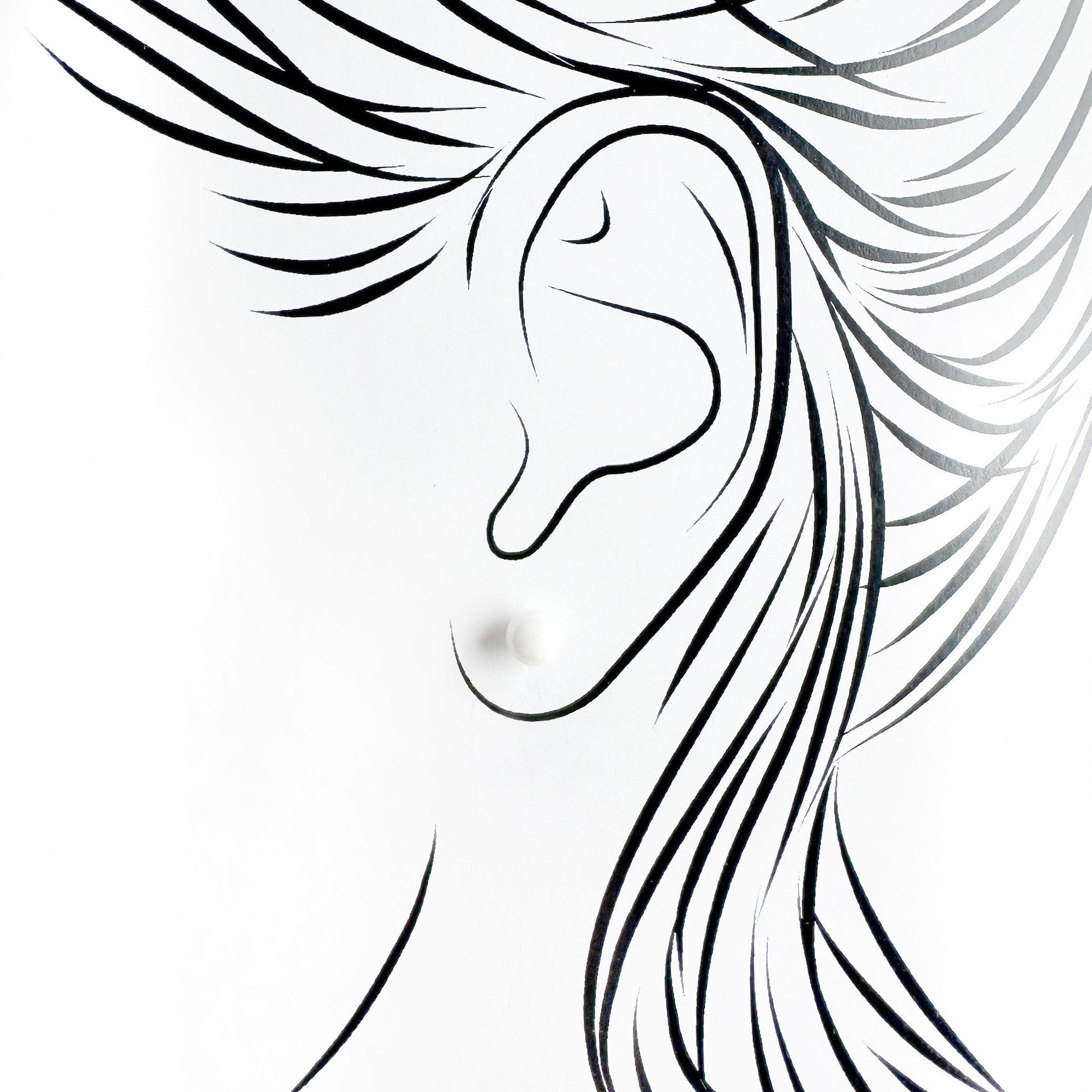 White ceramic stud earrings Sonata worn on the ear with a clean minimalist look