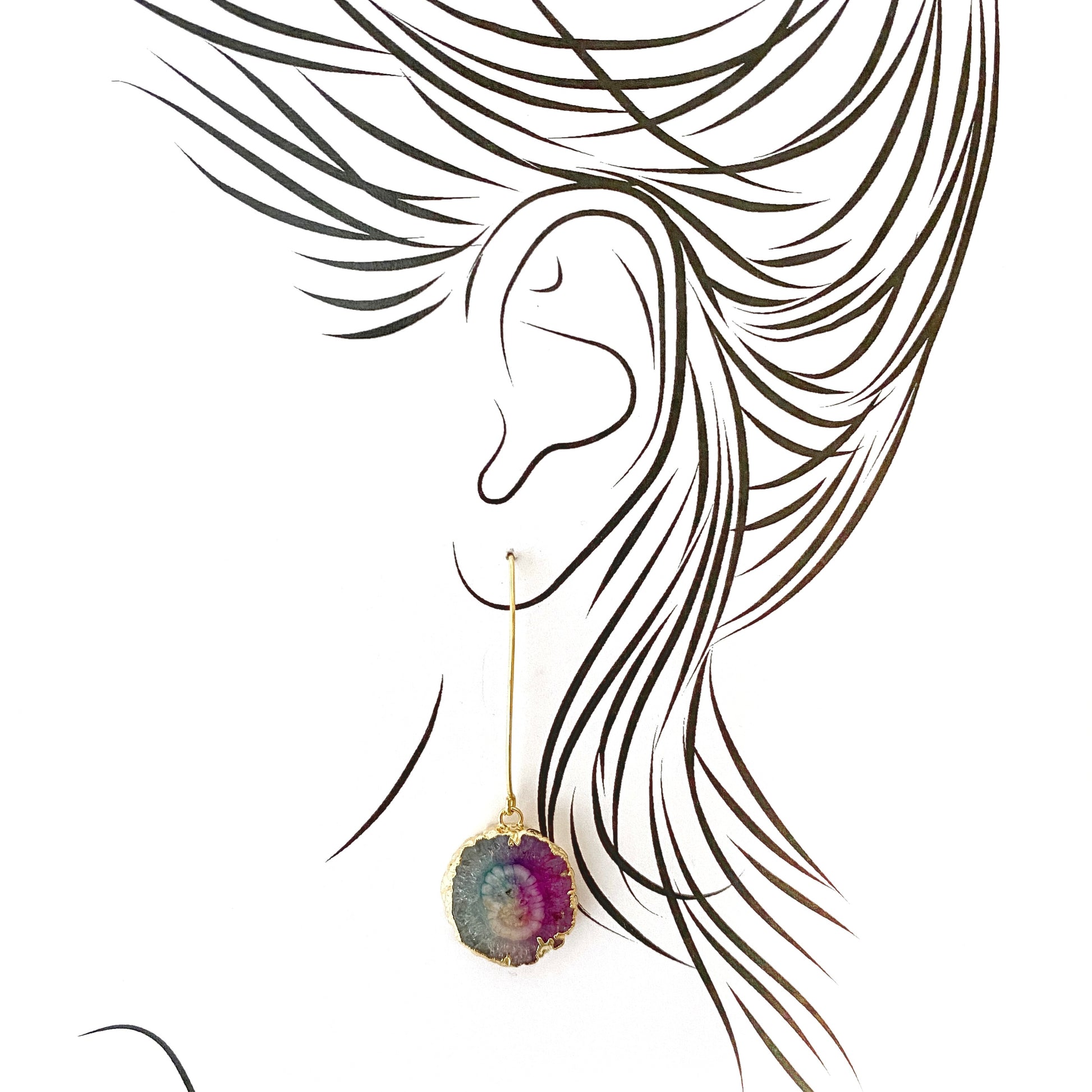 Artistic illustration of long gold-plated earrings with raw tourmaline stones